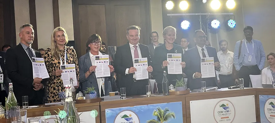 Action Plan released A group of people posing for a photo holding copies of the report.